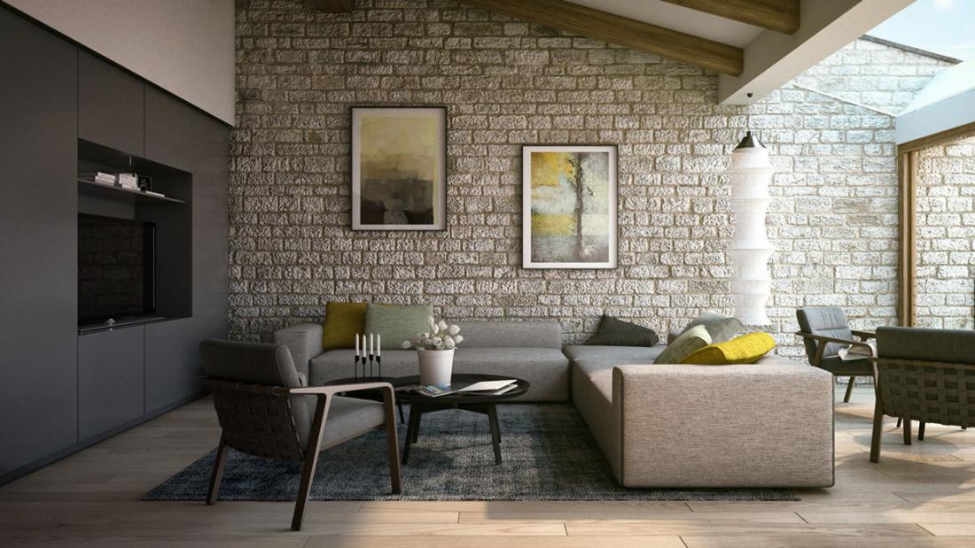 Stena iz kamna ustvari zanimiv kontrast ob modernem pohištvu ter tako nekoliko omehča minimalistično zasnovano dnevno sobo.